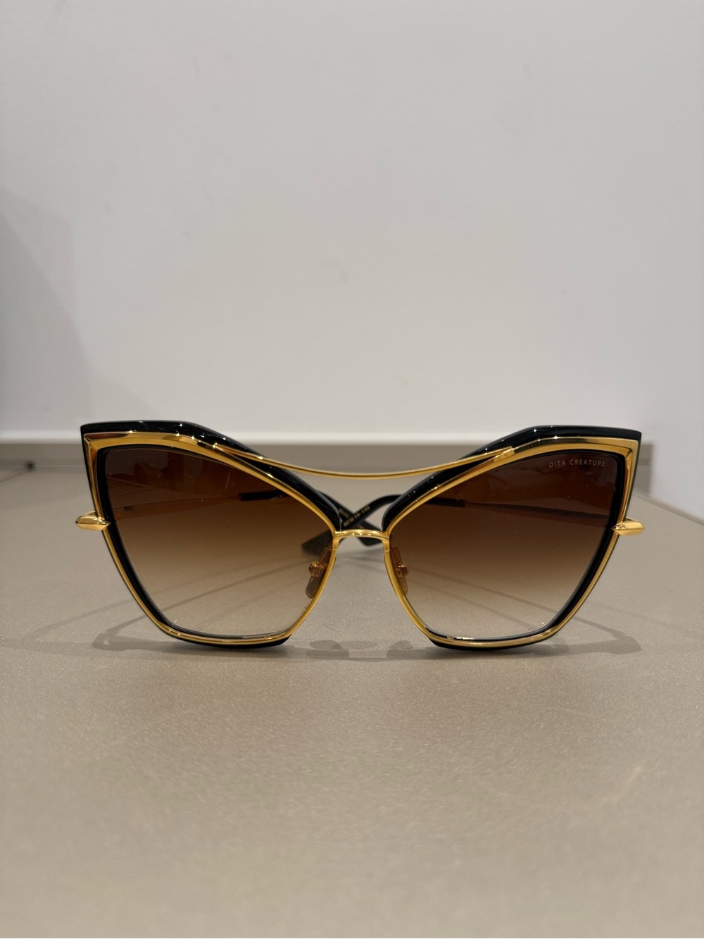 DITA Cat-Eye Sunglasses in Black and Gold with Brown Gradient Lenses
